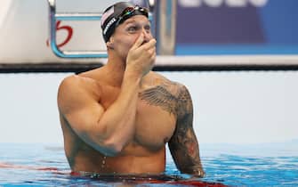 TOKYO, JAPAN - JULY 29: Caeleb Dressel of Team United States reacts after winning the gold medal in the Men's 100m Freestyle Final on day six of the Tokyo 2020 Olympic Games at Tokyo Aquatics Centre on July 29, 2021 in Tokyo, Japan. (Photo by Al Bello/Getty Images)