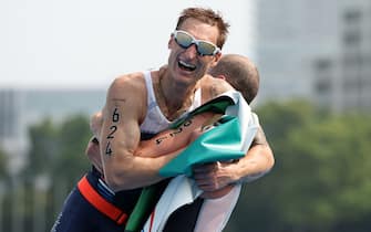 TOKYO, JAPAN - AUGUST 28: Brad Snyder and guide Greg Billington of Team United States react as they cross the finish line to win the gold medal during the men's PTVI Triathlon on day 4 of the Tokyo 2020 Paralympic Games at Odaiba Marine Park on August 28, 2021 in Tokyo, Japan. (Photo by Lintao Zhang/Getty Images)