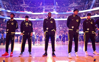 SAN FRANCISCO, CALIFORNIA - APRIL 27:  (L-R) Andrew Wiggins #22, Jordan Poole #3, Draymond Green #23, Kevon Looney #5, and Klay Thompson #11 of the Golden State Warriors stand for the national anthem before Game Five of the Western Conference First Round NBA Playoffs against the Denver Nuggets at Chase Center on April 27, 2022 in San Francisco, California. NOTE TO USER: User expressly acknowledges and agrees that, by downloading and/or using this photograph, User is consenting to the terms and conditions of the Getty Images License Agreement.  (Photo by Ezra Shaw/Getty Images)