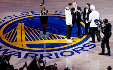 Golden State Warriors guard Stephen Curry (30) is presented with his championship ring by Warriors co-owners Joseph Lacob and Peter Guber during the ring ceremony before an NBA game between the Warriors and the Houston Rockets at Oracle Arena on Tuesday, Oct. 17, 2017, in Oakland, Calif.