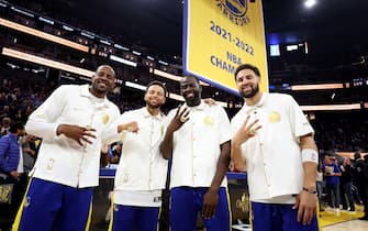 SAN FRANCISCO, CALIFORNIA - OCTOBER 18:  Andre Iguodala #9, Stephen Curry #30, Draymond Green #23, and Klay Thompson #11 of the Golden State Warriors pose with their championship rings in front of a championship banner during a ceremony prior to the game against the Los Angeles Lakers at Chase Center on October 18, 2022 in San Francisco, California. NOTE TO USER: User expressly acknowledges and agrees that, by downloading and or using this photograph, User is consenting to the terms and conditions of the Getty Images License Agreement. (Photo by Ezra Shaw/Getty Images)