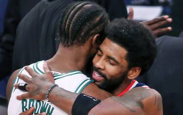 Brooklyn - April 25: The Celtics Jaylen Brown and the Nets Kyrie Irving embrace following the game. The Boston Celtics visited the Brooklyn Nets for Game Four of their first round NBA playoff series at Barclays Center in Brooklyn, NY on April 25, 2022. (Photo by Jim Davis/The Boston Globe via Getty Images)