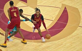 CLEVELAND, OHIO - NOVEMBER 18: Evan Mobley #4 helps Darius Garland #10 of the Cleveland Cavaliers drive to the basket around Terry Rozier #3 of the Charlotte Hornets during the first quarter at Rocket Mortgage Fieldhouse on November 18, 2022 in Cleveland, Ohio. NOTE TO USER: User expressly acknowledges and agrees that, by downloading and or using this photograph, User is consenting to the terms and conditions of the Getty Images License Agreement. (Photo by Jason Miller/Getty Images)