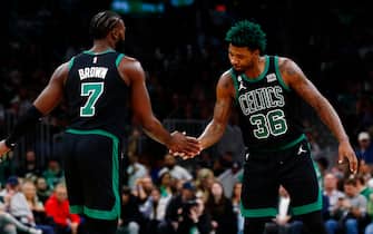 BOSTON, MASSACHUSETTS - NOVEMBER 25: Marcus Smart #36 of the Boston Celtics and Jaylen Brown #7 of the Boston Celtics low-five during the fourth quarter of the game against the Sacramento Kings at TD Garden on November 25, 2022 in Boston, Massachusetts. User expressly acknowledges and agrees that, by downloading and or using this photograph, User is consenting to the terms and conditions of the Getty Images License Agreement. (Photo by Omar Rawlings/Getty Images)