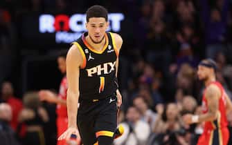 PHOENIX, ARIZONA - DECEMBER 17: Devin Booker #1 of the Phoenix Suns reacts after scoring against the New Orleans Pelicans during the second half of the NBA game at Footprint Center on December 17, 2022 in Phoenix, Arizona. The Suns defeated the Pelicans 118-114.  NOTE TO USER: User expressly acknowledges and agrees that, by downloading and or using this photograph, User is consenting to the terms and conditions of the Getty Images License Agreement. (Photo by Christian Petersen/Getty Images)