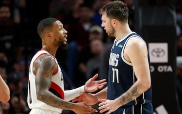 PORTLAND, OREGON - JANUARY 14: Damian Lillard #0 of the Portland Trail Blazers and Luka Doncic #77 of the Dallas Mavericks talk during the fourth quarter of the game at Moda Center on January 14, 2023 in Portland, Oregon. NOTE TO USER: User expressly acknowledges and agrees that, by downloading and or using this photograph, user is consenting to the terms and conditions of the Getty Images License Agreement. (Photo by Steph Chambers/Getty Images)