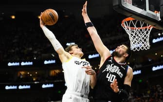 SALT LAKE CITY, UTAH - JANUARY 18: Lauri Markkanen #23 of the Utah Jazz dunks over Ivica Zubac #40 of the LA Clippers during the second half of a game at Vivint Arena on January 18, 2023 in Salt Lake City, Utah. NOTE TO USER: User expressly acknowledges and agrees that, by downloading and or using this photograph, User is consenting to the terms and conditions of the Getty Images License Agreement.  (Photo by Alex Goodlett/Getty Images)