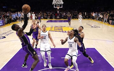 LOS ANGELES, CALIFORNIA - JANUARY 20: Dennis Schroder #17 of the Los Angeles Lakers scores to take a 122-120 lead in front of Ja Morant #12 and Desmond Bane #22 of the Memphis Grizzlies during the fourth quarter during a 122-121 Lakers win at Crypto.com Arena on January 20, 2023 in Los Angeles, California. (Photo by Harry How/Getty Images) NOTE TO USER: User expressly acknowledges and agrees that, by downloading and/or using this photograph, user is consenting to the terms and conditions of the Getty Images License Agreement.