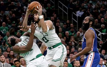 BOSTON, MA - February 8:  Jayson Tatum #0 of the Boston Celtics collides with Jaylen Brown #7 as James Harden #1 of the Philadelphia 76ers looks on during the first half of the NBA game at the TD Garden on February 8, 2023 in Boston, Massachusetts (Photo by Matt Stone/MediaNews Group/Boston Herald via Getty Images)