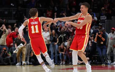 ATLANTA, GEORGIA - FEBRUARY 26:  Trae Young #11 of the Atlanta Hawks reacts with Bogdan Bogdanovic #13 after hitting the game-winning shot as time expires against the Brooklyn Nets at State Farm Arena on February 26, 2023 in Atlanta, Georgia.  NOTE TO USER: User expressly acknowledges and agrees that, by downloading and or using this photograph, User is consenting to the terms and conditions of the Getty Images License Agreement.  (Photo by Kevin C. Cox/Getty Images)