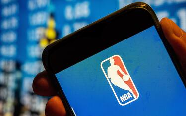 CHINA - 2022/07/25: In this photo illustration, the American National Basketball Association (NBA) men's professional basketball league logo is displayed on a smartphone screen. (Photo Illustration by Budrul Chukrut/SOPA Images/LightRocket via Getty Images)