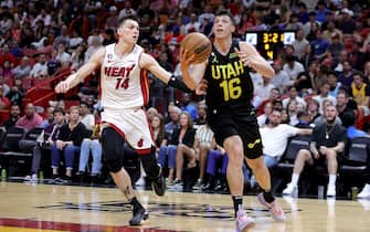 MIAMI, FLORIDA - MARCH 13: Simone Fontecchio #16 of the Utah Jazz drives past Tyler Herro #14 of the Miami Heat during the fourth quarter of the game at Miami-Dade Arena on March 13, 2023 in Miami, Florida. NOTE TO USER: User expressly acknowledges and agrees that, by downloading and or using this photograph, User is consenting to the terms and conditions of the Getty Images License Agreement. (Photo by Megan Briggs/Getty Images)