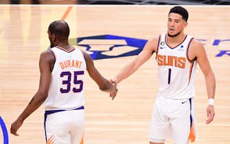 LOS ANGELES, CA - APRIL 22:  Kevin Durant #35 of the Phoenix Suns high fives Devin Booker #1 during the game against the LA Clippers during Round 1 Game 4 of the 2023 NBA Playoffs on April 22, 2023 at Crypto.Com Arena in Los Angeles, California. NOTE TO USER: User expressly acknowledges and agrees that, by downloading and/or using this Photograph, user is consenting to the terms and conditions of the Getty Images License Agreement. Mandatory Copyright Notice: Copyright 2023 NBAE (Photo by Adam Pantozzi/NBAE via Getty Images)