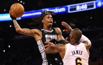 LOS ANGELES, CALIFORNIA - APRIL 22: Ja Morant #12 of the Memphis Grizzlies drives to the basket on LeBron James #6 of the Los Angeles Lakers during 111-101 Lakers win in Game Three of the Western Conference First Round Playoffs at Crypto.com Arena on April 22, 2023 in Los Angeles, California. NOTE TO USER: User expressly acknowledges and agrees that, by downloading and or using this photograph, User is consenting to the terms and conditions of the Getty Images License Agreement. (Photo by Harry How/Getty Images)