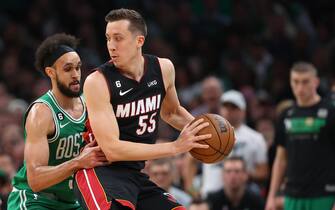 BOSTON, MASSACHUSETTS - MAY 25: Duncan Robinson #55 of the Miami Heat controls the ball ahead of Derrick White #9 of the Boston Celtics during the third quarter in game five of the Eastern Conference Finals at TD Garden on May 25, 2023 in Boston, Massachusetts. NOTE TO USER: User expressly acknowledges and agrees that, by downloading and or using this photograph, User is consenting to the terms and conditions of the Getty Images License Agreement. (Photo by Maddie Meyer/Getty Images)