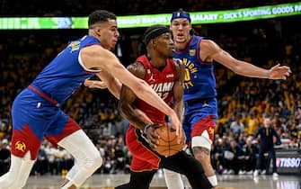 DENVER, CO - JUNE 1: Jimmy Butler (22) of the Miami Heat drives between Michael Porter Jr. (1) and Aaron Gordon (50) of the Denver Nuggets during the first quarter of the NBA Finals game 1 at Ball Arena in Denver on Thursday, June 1, 2023. (Photo by AAron Ontiveroz/The Denver Post)