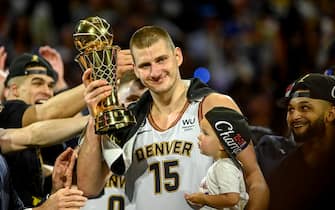 DENVER, CO - JUNE 12: Nikola Jokic (15) of the Denver Nuggets displays the NBA Finals Most Valuable Player Award as the star holds his daughter, Ognjena, after the fourth quarter of the Nuggets' 94-89 NBA Finals clinching win over the Miami Heat at Ball Arena in Denver on Monday, June 12, 2023. (Photo by AAron Ontiveroz/The Denver Post)
