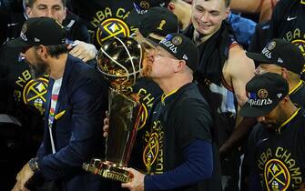 DENVER, CO - JUNE 12: Head Coach Michael Malone of the Denver Nuggets kisses the Larry O'Brien Championship Trophy during Game Five of the 2023 NBA Finals on June 12, 2023 at the Ball Arena in Denver, Colorado. NOTE TO USER: User expressly acknowledges and agrees that, by downloading and/or using this Photograph, user is consenting to the terms and conditions of the Getty Images License Agreement. Mandatory Copyright Notice: Copyright 2023 NBAE (Photo by Bart Young/NBAE via Getty Images)