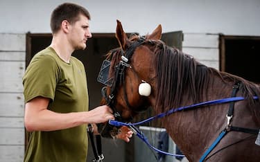 BELGRADE, SERBIA - JUNE 23: Serbian professional basketball player Nikola Jokic of the Denver Nuggets leads his horse to the stable area after the race at Beogradski hipodrom on June 23, 2019 in Belgrade, Serbia. (Photo by Srdjan Stevanovic/Getty Images)