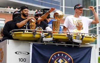 DENVER, COLORADO - JUNE 15: Jamal Murray #27 and Nikola Jokic #15 wave to fans near the Larry O'Brien Championship Trophy during the Denver Nuggets victory parade and rally after winning the 2023 NBA Championship on June 15, 2023 in Denver, Colorado. NOTE TO USER: User expressly acknowledges and agrees that, by downloading and or using this photograph, User is consenting to the terms and conditions of the Getty Images License Agreement. (Photo by Justin Edmonds/Getty Images)