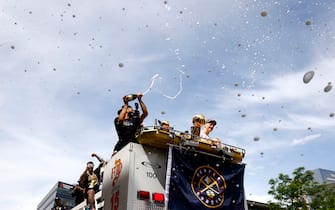 DENVER, COLORADO - JUNE 15: Jamal Murray #27 sprays champagne with Nikola Jokic #15 and the Larry O'Brien Championship Trophy during the Denver Nuggets victory parade and rally after winning the 2023 NBA Championship on June 15, 2023 in Denver, Colorado. NOTE TO USER: User expressly acknowledges and agrees that, by downloading and or using this photograph, User is consenting to the terms and conditions of the Getty Images License Agreement. (Photo by Justin Edmonds/Getty Images)