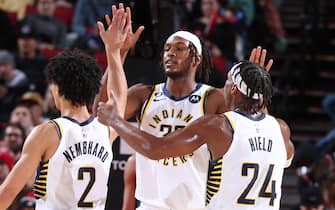 PORTLAND, OR - DECEMBER 4: Myles Turner #33 of the Indiana Pacers high fives Andrew Nembhard #2 and Buddy Hield #24 of the Indiana Pacers during the game against the Portland Trail Blazers on December 4, 2022 at the Moda Center Arena in Portland, Oregon. NOTE TO USER: User expressly acknowledges and agrees that, by downloading and or using this photograph, user is consenting to the terms and conditions of the Getty Images License Agreement. Mandatory Copyright Notice: Copyright 2022 NBAE (Photo by Sam Forencich/NBAE via Getty Images)