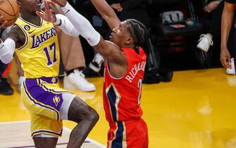 Los Angeles Lakers guard Dennis Schroder (2nd R) drives to ball between New Orleans Pelicans guards CJ McCollum (2nd L) and Josh Richardson (R) during an NBA basketball game in Los Angeles.