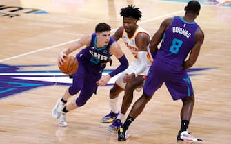 CHARLOTTE, NORTH CAROLINA - JANUARY 09: LaMelo Ball #2 of the Charlotte Hornets drives to the basket against Cam Reddish #22 of the Atlanta Hawks during the fourth quarter of their game at Spectrum Center on January 09, 2021 in Charlotte, North Carolina. NOTE TO USER: User expressly acknowledges and agrees that, by downloading and or using this photograph, User is consenting to the terms and conditions of the Getty Images License Agreement. (Photo by Jared C. Tilton/Getty Images)