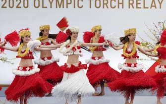 epa09095145 Members of the Spa Resort Hawaiians Dancing Team 'Hula Girls' perform during an opening performance on the first day of the Tokyo 2020 Olympic torch relay in Naraha, Fukushima prefecture, Japan, 25 March 2021.  EPA/KIM KYUNG-HOON / POOL