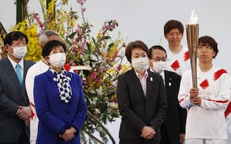 epa09095184 Tokyo's governor Yuriko Koike (2-L) and Tokyo 2020 President Seiko Hashimoto (4-R) wear face masks as they attend the Tokyo 2020 Olympic Torch Relay Grand Start in Naraha, Fukushima prefecture, Japan, 25 March 2021. The postponed Tokyo 2020 Olympic Games are scheduled to start on 23 July 2021 and some 10,000 torchbearers will run across the country along a 121-day journey.  EPA/KIM KYUNG-HOON / POOL