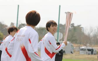 epa09095182 Azusa Iwashimizu (R) and other members of Japan women's national football team Nadeshiko Japan, run as torchbearers in the first leg of the torch relay for the Tokyo Olympic Games at the J-Village National Training Center in Futaba, Fukushima prefecture, Japan, 25 March 2021. The postponed Tokyo 2020 Olympic Games are scheduled to start on 23 July 2021 and some 10,000 torchbearers will run across the country along a 121-day journey.  EPA/Du Xiaoyi / POOL