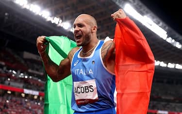 Italy's Lamont Marcell Jacobs celebrates after winning the men's 100m final during the Tokyo 2020 Olympic Games at the Olympic Stadium in Tokyo on August 1, 2021. (Photo by Cameron Spencer / POOL / AFP) (Photo by CAMERON SPENCER/POOL/AFP via Getty Images)