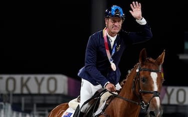 TOKYO, JAPAN - AUGUST 10: Australia's Andrew Hoy rides in the ring after receiving his bronze medal in the equestrian event jumping individual final at Equestrian Park at the 2020 Summer Olympics on August 10, 2021 in Tokyo, Japan. (Photo by Carolyn Kaster-Pool/Getty Images)