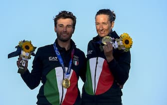 Italy's Ruggero Tita and Caterina Banti, gold medal, pose on the podium  aftyer the mixed multihull Nacra 17 foiling race during the Tokyo 2020 Olympic Games sailing competition at the Enoshima Yacht Harbour in Fujisawa, Kanagawa Prefecture, Japan, on August 3, 2021. (Photo by Olivier MORIN / AFP) (Photo by OLIVIER MORIN/AFP via Getty Images)