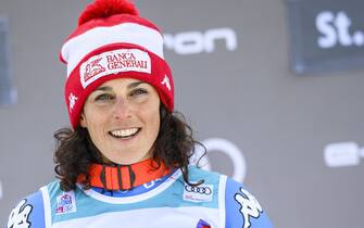 epa09637987 Winner Federica Brignone of Italy smiles during the podium ceremony of the women's Super-G race at the FIS Alpine Skiing World Cup event in St. Moritz, Switzerland, 12 December 2021.  EPA/PETER SCHNEIDER