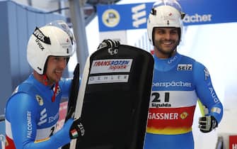 epa09673850 Emanuel Rieder (R) and Simon Kainzwaldner of Italy react at the finish area during the second run of the Doubles competition at the FIL Luge World Cup in Sigulda, Latvia, 08 January 2021.  EPA/TOMS KALNINS