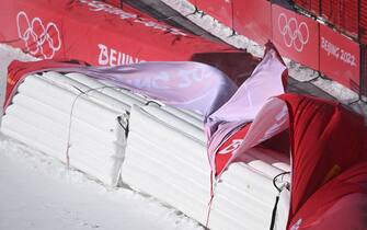 Strong winds lift covers before the mixed team parallel round of 16 event during the Beijing 2022 Winter Olympic Games at the Yanqing National Alpine Skiing Centre in Yanqing on February 19, 2022. - The last Olympics alpine ski event of the Beijing Games will not take place today because of strong winds, officials said, with talks ongoing on a potential rescheduling. (Photo by Fabrice COFFRINI / AFP) (Photo by FABRICE COFFRINI/AFP via Getty Images)