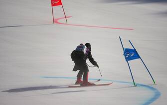 19 February 2022, China, Yanqing: Olympics, Alpine Skiing, Team, Mixed, Round of 16 at the National Alpine Ski Center, a staff member marks the slope before the Round of 16. Photo: Michael Kappeler/dpa (Photo by Michael Kappeler/picture alliance via Getty Images)
