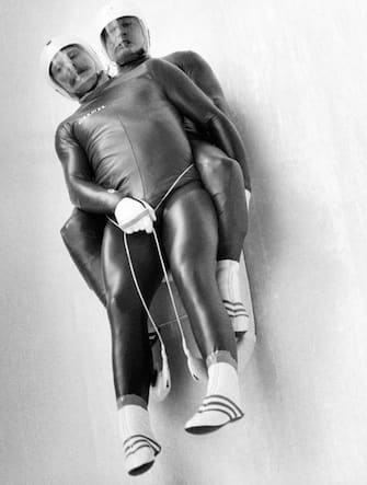 Italian Peter Gschnitzer and Karl Brunner are in action during the men's double luge on February 10, 1980 at Lake Placid as part of the 1980 Winter Olympic Games. The Italian luge couple took the silver medal. (Photo by Roger SCHMIDT / EPU / AFP) (Photo by ROGER SCHMIDT/EPU/AFP via Getty Images)