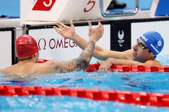 TOKYO, JAPAN - AUGUST 31: Maksym Krypak (L) of Team Ukraine is congratulated by Stefano Raimondi of Team Italy after winning gold in the Menâ  s 100m Butterfly - S10 Final on day 7 of the Tokyo 2020 Paralympic Games at Tokyo Aquatics Centre on August 31, 2021 in Tokyo, Japan. His timing of 54.15s is a new world record. (Photo by Lintao Zhang/Getty Images)