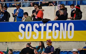 Ukraine's colours reading "Support" in Italian are pictured in a tribune prior to the Six Nations international rugby union match between Italy and Scotland on March 12, 2022 at the Olympic stadium in Rome. (Photo by Alberto PIZZOLI / AFP) (Photo by ALBERTO PIZZOLI/AFP via Getty Images)