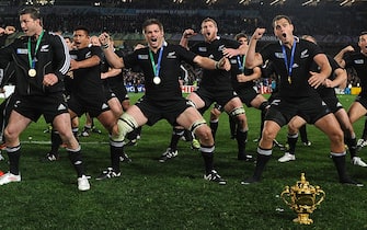 New Zealand All Blacks including New Zealand All Blacks captain Richie McCaw (C) perform a victory Haka behind the Webb Ellis cup after the 2011 Rugby World Cup final match New Zealand vs France at Eden Park Stadium in Auckland on October 23, 2011.                 AFP PHOTO / FRANCK FIFE (Photo credit should read FRANCK FIFE/AFP via Getty Images)