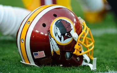 LANDOVER, MD - AUGUST 18: A Washington Redskins helmet sits on the grass during a preseason football game between the Redskins and Cleveland Browns at FedExField on August 18, 2014 in Landover, Maryland.  (Photo by TJ Root/Getty Images)