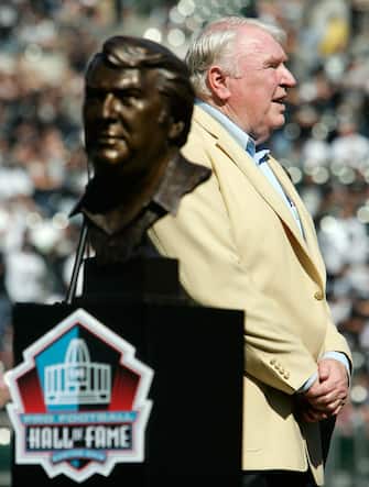 OAKLAND, CA - OCTOBER 22:  Former Head Coach John Madden of the Oakland Raiders looks on alongside his Hall of Fame Bust during a ceremony to honor his recent induction into the Pro Football Hall of Fame before the game against the Arizona Cardinals on October 22, 2006 at McAfee Coliseum in Oakland, California.  (Photo by Jonathan Ferrey/Getty Images)