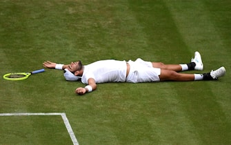 LONDON, ENGLAND - JULY 08:  Matteo Berrettini of Italy reacts on the ground after falling in his Men's Singles fourth round match against Roger Federer of Switzerland during Day Seven of The Championships - Wimbledon 2019 at All England Lawn Tennis and Croquet Club on July 08, 2019 in London, England. (Photo by Shaun Botterill/Getty Images)