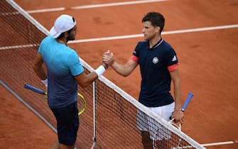 Austria's Dominic Thiem (R) shakes hands as he celebrates after victory over Italy's Matteo Berrettini during their men's singles third round match on day six of The Roland Garros 2018 French Open tennis tournament in Paris on June 1, 2018. (Photo by Eric FEFERBERG / AFP)        (Photo credit should read ERIC FEFERBERG/AFP via Getty Images)
