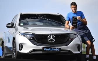 Italy's Matteo Berrettini poses with his trophy next to the full electric Mercedes-Benz EQC Edition 1886 that he won after defeating Canada's Felix Auger-Aliassime in their final at the ATP Mercedes Cup tennis tournament in Stuttgart, southwestern Germany, on June 16, 2019. (Photo by THOMAS KIENZLE / AFP)        (Photo credit should read THOMAS KIENZLE/AFP via Getty Images)