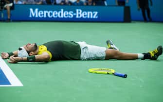 NEW YORK, NEW YORK - SEPTEMBER 04: Matteo Berrettini of Italy falls to the court in celebration of his Men's Singles quarterfinals victory against Gael Monfils of France on day ten of the 2019 US Open at the USTA Billie Jean King National Tennis Center on September 04, 2019 in Queens borough of New York City. (Photo by Chaz Niell/Getty Images)