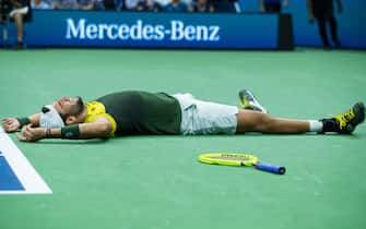 1172333829 NEW YORK, NEW YORK - SEPTEMBER 04: Matteo Berrettini of Italy falls to the court in celebration of his Men's Singles quarterfinals victory against Gael Monfils of France on day ten of the 2019 US Open at the USTA Billie Jean King National Tennis Center on September 04, 2019 in Queens borough of New York City. (Photo by Chaz Niell/Getty Images)