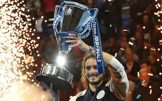 1183111472 Greece's Stefanos Tsitsipas poses with the winner's trophy after winning the men's singles final match on day eight of the ATP World Tour Finals tennis tournament at the O2 Arena in London on November 17, 2019. - Tsitsipas beat Austria's Dominic Thiem to win the match 6-7, 6-2, 7-6. (Photo by Glyn KIRK / AFP) (Photo by GLYN KIRK/AFP via Getty Images)